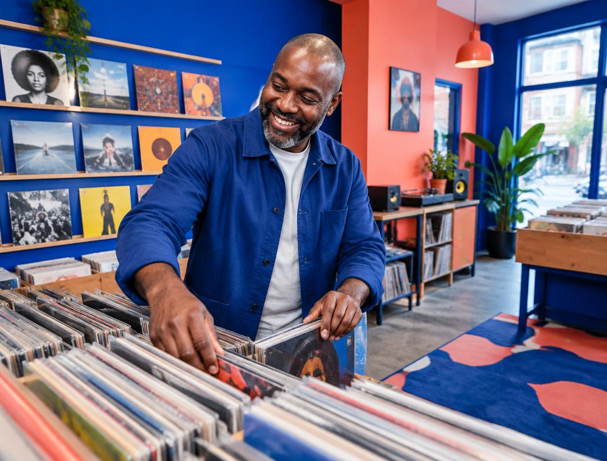 Record shop owner organizing vinyl in his store